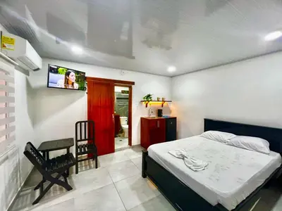 a bedroom with a bed and a tv on the wall at Sol de Coveñas Caracol in Guayabal