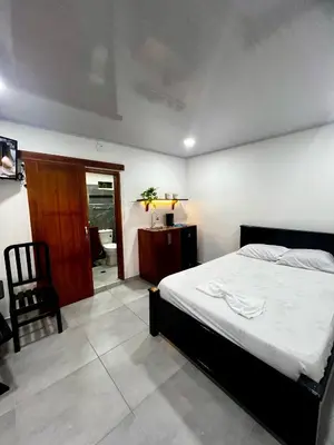 a bedroom with a bed and a chair in it at Sol de Coveñas Caracol in Guayabal