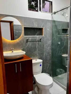 a bathroom with a toilet and a sink and a shower at Sol de Coveñas Caracol in Guayabal