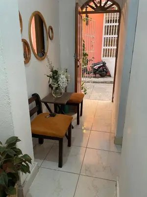 a hallway with a table and a chair and a mirror at Casa Vilmar Getsemani in Cartagena de Indias