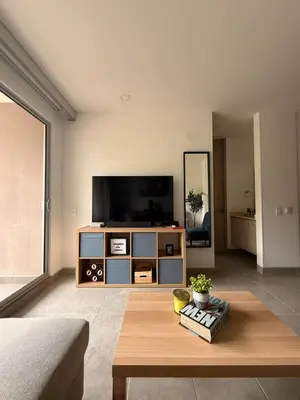 a living room with a tv and a coffee table at Modern Apartment in Santa Marta in Santa Marta