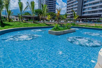a swimming pool with blue water in a resort at Modern Apartment in Santa Marta in Santa Marta