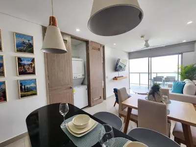 a kitchen and dining room with a table and chairs at Bocagrande bay view gym jacuzzi pool in Cartagena de Indias