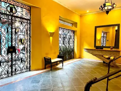 a room with a door with a bench and a mirror at by Calamari Homes - El Porvenir 207 walled city in Cartagena de Indias