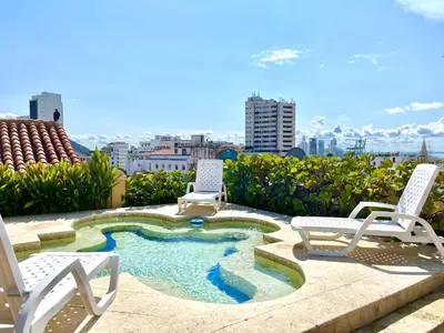 a patio with two chairs and a small pool at by Calamari Homes - El Porvenir 207 walled city in Cartagena de Indias
