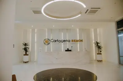 a lobby with a reception desk in a building at Modern Apartasuit Cartagena Beach in Cartagena de Indias