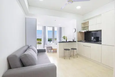 a living room with a couch and a kitchen at Apartasuit Cartagena luxury 1240 in Cartagena de Indias