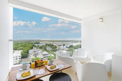 a dining room with a view of the ocean at Luxurious Apartasuit CartagenaBeach1139 in Cartagena de Indias