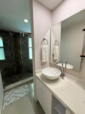 a white bathroom with a sink and a shower at Exclusivo apartamento de lujo frente al mar en Los Morros, con acceso directo y privado a la mejor playa de Cartagena in Cartagena de Indias