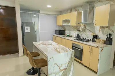 a kitchen with a marble counter top and a chair at Exclusivo apartamento de lujo frente al mar en Los Morros, con acceso directo y privado a la mejor playa de Cartagena in Cartagena de Indias