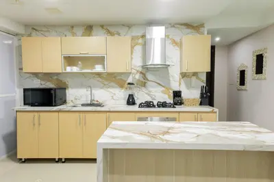 a kitchen with a marble counter top and a kitchen island at Exclusivo apartamento de lujo frente al mar en Los Morros, con acceso directo y privado a la mejor playa de Cartagena in Cartagena de Indias