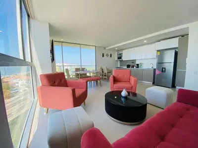 a living room with red furniture and a kitchen at Premium Hub 1304 APARTAMENTO CARTAGENA Vista al Mar in Cartagena de Indias