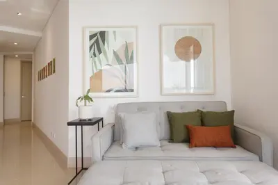 a white living room with a couch with pillows at Murano Elite by MOME in Cartagena de Indias