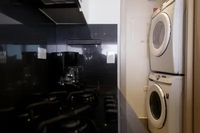 a kitchen with a washing machine and a washer at Murano Elite by MOME in Cartagena de Indias