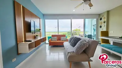 a living room with a couch and a tv at Apartamentos en Cielo Mar Por Parceros Group in Cartagena de Indias