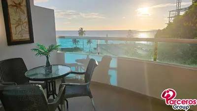a balcony with a table and chairs and a view of the ocean at Apartamentos Torres Del Lago Por Parceros Group in Cartagena de Indias