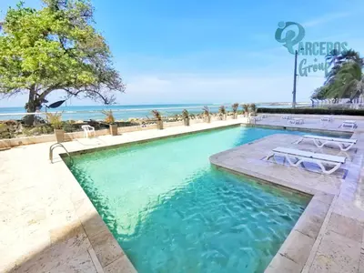 a swimming pool with the ocean in the background at Apartamentos Palmetto Sunset por Parceros Group in Cartagena de Indias