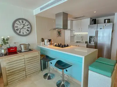 a kitchen with a counter and a clock on the wall at Hotel Radisson Residences Ocean Pavillion in Cartagena de Indias