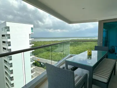 a balcony with a table and chairs and a view of the ocean at Hotel Radisson Residences Ocean Pavillion in Cartagena de Indias
