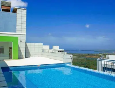 a swimming pool on the side of a building at Bluegardens Apartment, Central with Beautiful View in Barranquilla