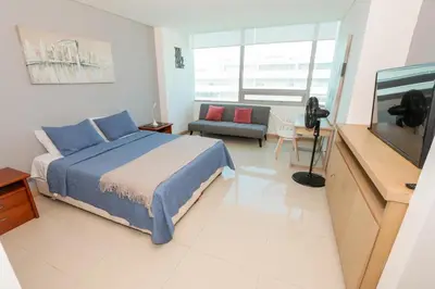 a bedroom with a bed and a flat screen tv at Bluegardens Apartment, Central with Beautiful View in Barranquilla