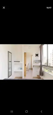 a white room with a mirror and a window at El Laguito Apartamento in Cartagena de Indias