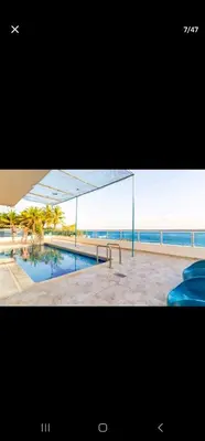a picture of a swimming pool next to the ocean at El Laguito Apartamento in Cartagena de Indias