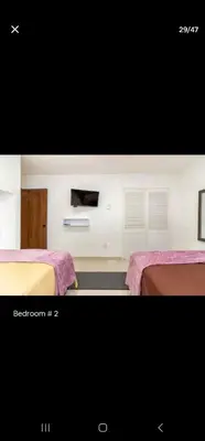 a bedroom with two beds with pink blankets at El Laguito Apartamento in Cartagena de Indias
