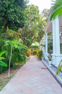 a walkway leading to a house with trees at Casa Niza - Colonial house in Cartagena de Indias