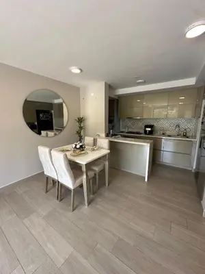 a kitchen and dining room with a table and chairs at Luxury loft with home theater & pool, Buenavista top location in Barranquilla