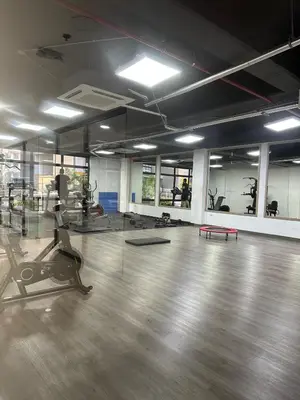 an empty gym with a wooden floor and mirrors at Luxury loft with home theater & pool, Buenavista top location in Barranquilla