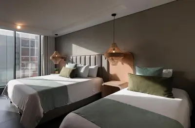 a hotel room with two beds and a window at OZ Hotel Collection in Cartagena de Indias