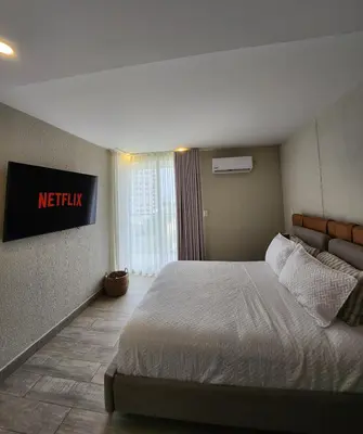 a hotel room with a bed and a sign on the wall at Dominique 609 Apartment with private jacuzzi in Cartagena de Indias