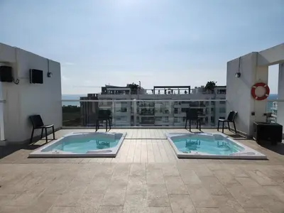 two swimming pools on the roof of a building at Dominique 609 Apartment with private jacuzzi in Cartagena de Indias
