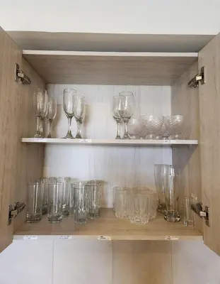 a bunch of glasses sitting on shelves in a room at Dominique 609 Apartment with private jacuzzi in Cartagena de Indias