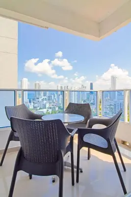 a table and chairs in a room with a view of a city at Espectacular vista piso 20 in Cartagena de Indias