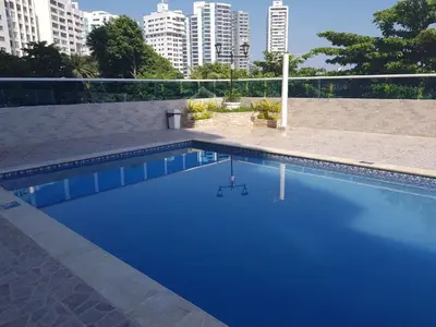 a blue swimming pool with buildings in the background at Espectacular vista piso 20 in Cartagena de Indias