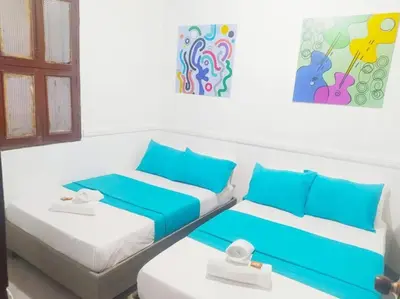 two beds in a room with blue and white at Agradable apto en el centro histórico in Cartagena de Indias