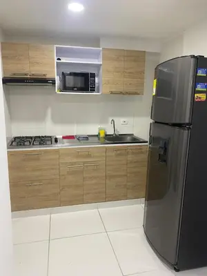 a kitchen with a stainless steel refrigerator and a microwave at Apartamento alameda del Rio in Barranquilla