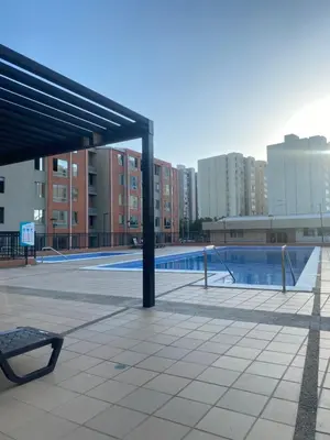 an empty swimming pool in a city with buildings at Apartamento alameda del Rio in Barranquilla