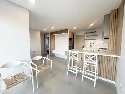 a kitchen with white chairs and a table and a counter at Oasis Vista al Mar in Cartagena de Indias