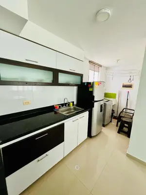 a kitchen with a sink and a refrigerator at Apartamento en Sabanilla in Puerto Colombia