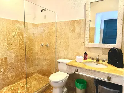 a bathroom with a toilet and a shower and a sink at by Calamari Homes - El Porvenir 306 walled city in Cartagena de Indias