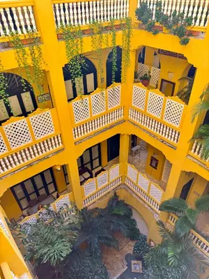 an overhead view of a yellow building with plants at by Calamari Homes - El Porvenir 306 walled city in Cartagena de Indias