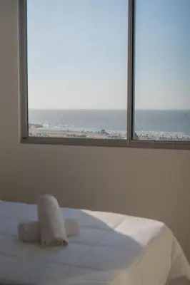 a bedroom with a window with a view of the ocean at Premium Hub Ocean View Apartment in Cartagena 905 in Cartagena de Indias