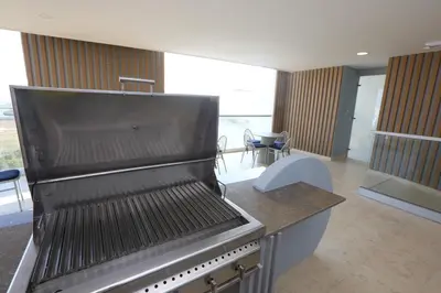 a kitchen with a grill with a table and chairs at Premium Hub Ocean View Apartment in Cartagena 905 in Cartagena de Indias