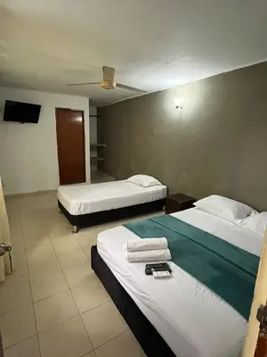 a hotel room with two beds and a tv at Stay Mar y Playa House in Cartagena de Indias