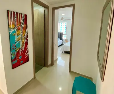 a hallway leading to a bedroom with a painting on the wall at Confort Total con Vista al Mar 11 in Cartagena de Indias