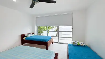 a room with two beds and a window at Cabaña Costa de Oro in San Antero