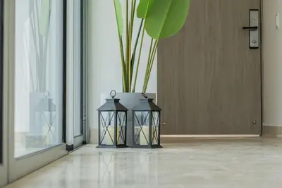 a black lantern with a plant in a room at CB1629 | Suite moderna con vista 180 mar ciudad in Cartagena de Indias